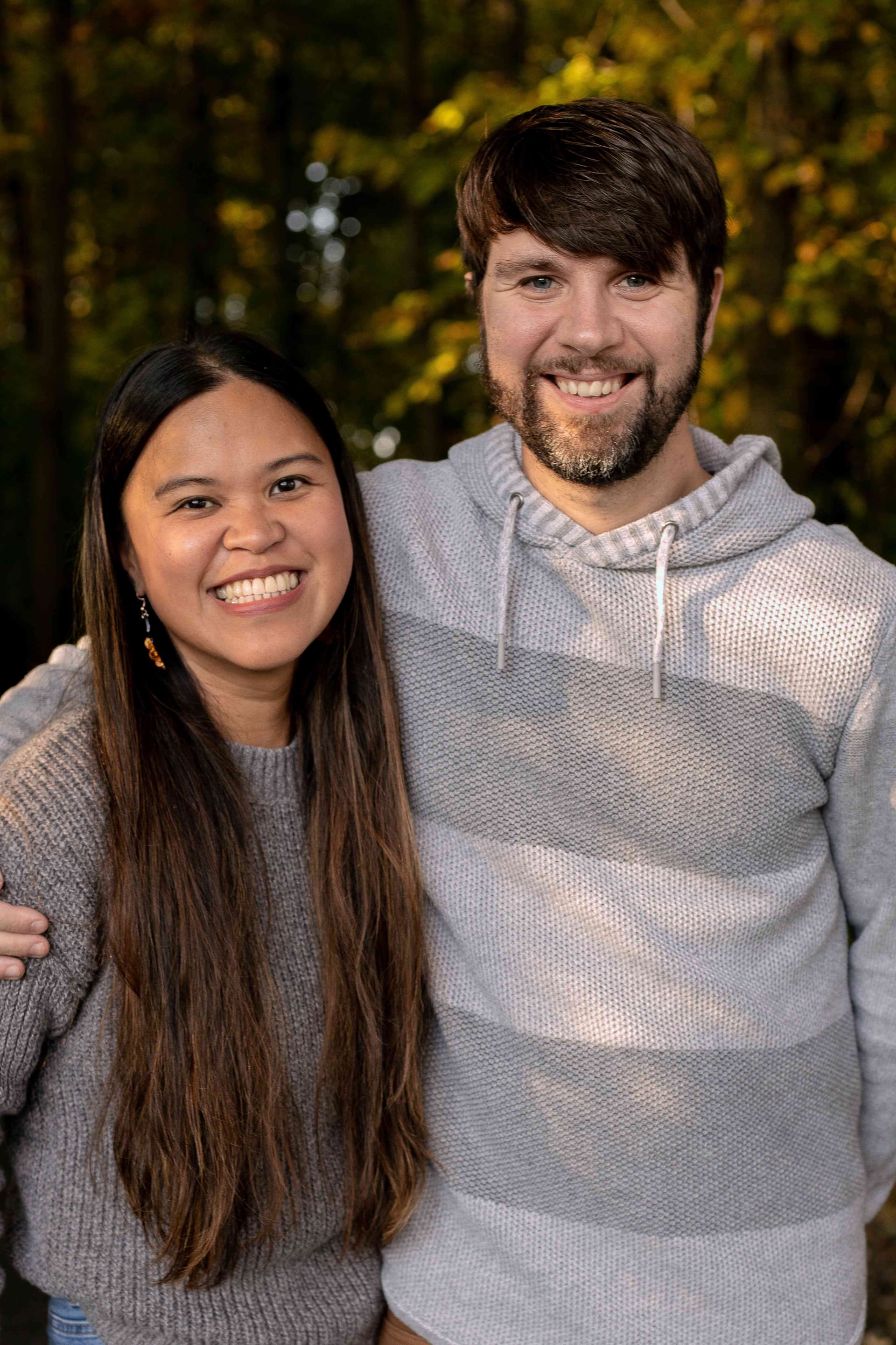 Kristy and her husband James in the autumn woods