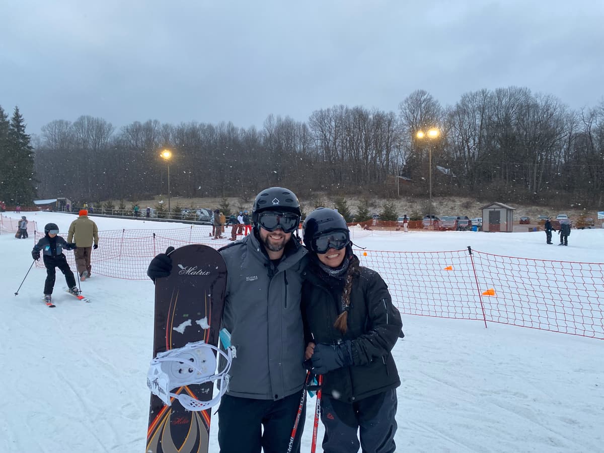 Kristy and James skiing on a snowy slope